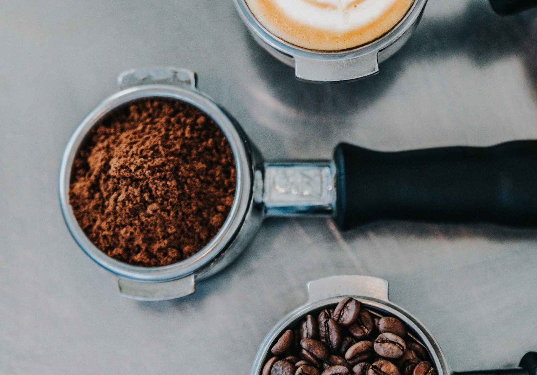 flat lay photography of coffee latte, ground coffee, and coffee beans